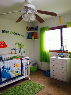 a child's room with green curtains and white furniture