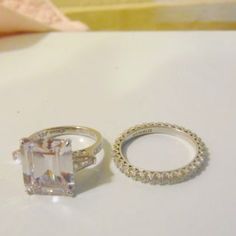 two wedding rings sitting next to each other on a table