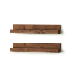 two wooden shelves on the wall, one with wood planks and one without it