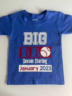 "Item details below: Big Bro Shirt - Big Brother Announcement Shirt - Pregnancy Announcement Shirt - Big Bro Shirt - Big Brother Baseball Shirt - New Baby Announcement Big Bro This is the sweetest shirt for a new big brother if you are looking to share the news in a BASEBALL theme! (Please note- other sports can be switched out!) Just let me know the date you want this customized with! I have three color options set up on this listing. All will come with white and red graphics. But please contac Baseball Big Brother Announcement, Customizable Blue Tops For Baseball Season, Family Matching Blue Pre-shrunk Shirt, Blue Short Sleeve Shirt For Baseball Season, Blue Pre-shrunk Family Matching Shirt, Family Matching Blue Shirt With Name Print, Customizable Short Sleeve Tops For Gender Reveal, Brother Announcement, Big Bro Shirt