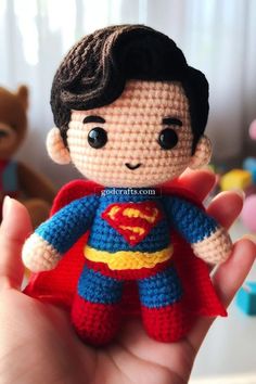 a small crocheted superman doll is held in the palm of someone's hand