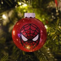 a spiderman ornament hanging from a christmas tree