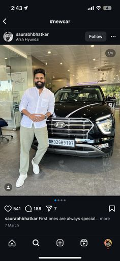 a man standing next to a car in a showroom