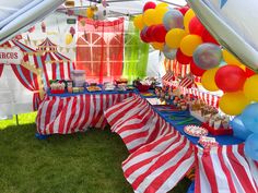 a circus themed birthday party with balloons and desserts on the tables in front of it