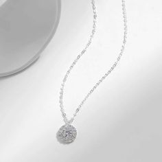 Enhance your style with our dazzling Olivia necklace, featuring a sparkling zircon pendant. Add a touch of elegance and glamour to any outfit with this eye-catching accessory. Elevate your look and make a statement with Olivia. Dainty Sparkling Necklace For Party, Diamond White Crystal Solitaire Pendant Necklace, Elegant Round Crystal Necklaces, Cubic Zirconia Crystal Pendant Necklace With Clavicle Chain, Dazzling Cubic Zirconia Diamond Necklace With Flower Pendant, Dazzling Diamond White Pendant Necklace, Dazzling Diamond White Solitaire Crystal Necklace, Cubic Zirconia Rhinestone Necklace With Round Pendant, Cubic Zirconia Round Pendant Necklace