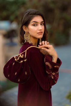 PRODUCT DETAIL: This wine velvet set comes laden with delicate and beautiful embroidery. It is accompanied by tulip pants with delicate embroidered motifs. The overall look can be enhanced with a matching wine embroidered potli.  *Dry Clean only SPECIFICATIONS: Color Wine Fabric Suit: Velvet  Dupatta: Semi Organza Prod Suit With Tulip Pants, Wine Velvet Suit, Velvet Dupatta, Tulip Pants, Velvet Dress Designs, Velvet Set, Embroidered Motifs, Velvet Suit, Designer Dresses Casual