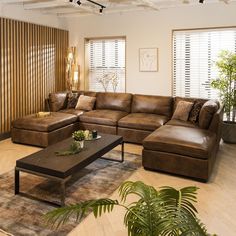 a living room filled with lots of brown furniture