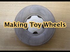 a toy wheel sitting on top of a wooden table with the words making toy wheels above it