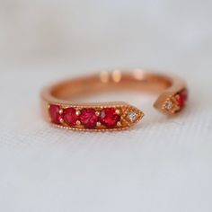 This ring features red spinels and diamonds with the most fascinating red color. The size 6.75 ring is made of solid 18K gold can be sized up or down for $65 if needed. This item is brand new and was appraised by a gemologist. The certificate will be included and describes the spinel as follows: Condition: Brand New & Custom Designed by me  Size: US 6.75 sizable  Metal: Solid 14K Rose Gold  Center Stone: Vivid Red Spinels 0.62ct.  Side Stones: Earth Mined Diamonds 0.05ct  Measurement: 4mm front Luxury Red Rings With Diamond Accents, Red Open Diamond Promise Ring, Luxury Red Diamond Ring With Single Cut Diamonds, Lab-created Ruby Rings With Rose Cut Diamonds For Promise, Red Ruby Ring With Single Cut Diamonds, Red 14k Gold Birthstone Ring For Promise, Red Sapphire Ring With Prong Setting For Anniversary, Red Birthstone Ring With Rose Cut Diamonds, Promise Ring With Rose Cut Diamonds And Lab-created Ruby