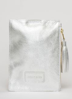 This bag is made from high-quality, super-soft metallic silver leather sourced from a premiere hide house in California. The leather is shipped to New York City, where our bags are produced by expert craftsmen and finished with a smooth zipper, leather tassel, and bamboo ring. Just big enough for all your essentials, we designed the Ring Wristlet to be your go-to bag for going out! Whether you’re heading to a cocktail party, a concert, or out on the town, slip it on your wrist so your hands are Modern Silver Soft Leather Bag, Silver Leather Pouch Bag, Silver Pouch Clutch For Travel, Silver Pouch For Everyday Use, Silver Pouch With Removable Pouch For Everyday Use, Silver Clutch With Removable Pouch For Daily Use, House In California, Hidden House, Acrylic Ring