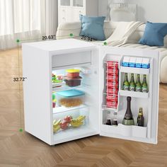 an open refrigerator sitting on top of a hard wood floor next to a white couch