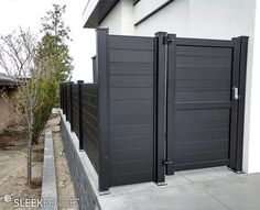 two black gates on the side of a house