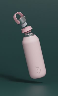 a pink water bottle with a metal cap and an apple logo on the side, sitting in front of a green background