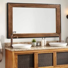 a bathroom with two sinks and a large mirror