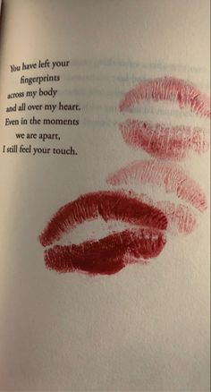 an open book with two lipstick imprints on it