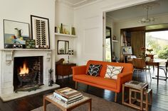 a living room filled with furniture and a fire place in the middle of a room