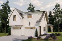 a white house with two garages and trees in the background