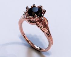 a rose shaped ring with a black diamond in the center