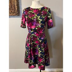 This Pretty Dress Is From Jessica Howard In A Misses Size 8. Soft And Stretchy, Made Of 94% Polyester And 6% Spandex. Polyester Lining. Machine Washable. Has An A Line Fit With Back Zipper. Unstretched, Measured From Seam To Seam Across The Front: Bust Is 18.5 Inches Across Waist Is 15.5 Inches Across Hips Are 21 Inches Across Sleeves Are 11 Inches Long Length Is 36.5 Inches Long New Without Tags- The Hem Is Loose And Needs A Quick Stitch. From A Smoke Free Home. Thanks For Shopping With Me. Purple A-line Midi Dress With Floral Print, Purple Fitted A-line Midi Dress, Purple Floral Print A-line Midi Dress, Jessica Howard Dress, Quick Stitch, Jessica Howard, Pretty Dress, Size 8 Dress, Long Length