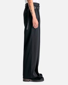 Acne Studios Piana Light Dry Suiting Trouser in Black. These tailored trousers feature a pre-constructed waistband and wrap around skirt that is the length of the pant. A leather belt fastens the wrap to the opposite side of the waist. Traditional zip fly and hook closure can be found under the wrap along with three-pocket styling and pressed creases. Sleek Wide Leg Pants For Evening With Belt Loops, Sleek Wide Leg Pants With Belt Loops For Evening, Formal Black Belted Pants, Black Wide Leg Pants With Belt Detail, Black Wide Leg Bottoms With Belt Detail, Elegant Black Pants With Belt, Sleek Full Length Wide Leg Pants With Belt Loops, Belted Wide-leg Formal Pants, Formal Wide-leg Belted Pants