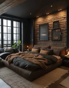 a large bed sitting in the middle of a bedroom next to a window with candles on it