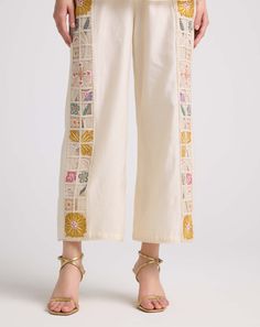 Dress with sophistication in this ivory chanderi pants, delicately embroidered and featuring a charming checkered pattern. These pants exude elegance and charm, offering a refined addition to your wardrobe. Luxury Embroidered Elegant Pants, Luxury Embroidered Pants For Festive Season, Luxury Pants With Pearl Embroidery, Luxury Fitted Pants With Chikankari Embroidery, Luxury Straight Pants With Chikankari Embroidery, Luxury Women's Bottoms With Chikankari Embroidery, Luxury Wedding Pants With Chikankari Embroidery, Luxury Festive Pants With Intricate Embroidery, Luxury Festive Pants With Embroidered Border