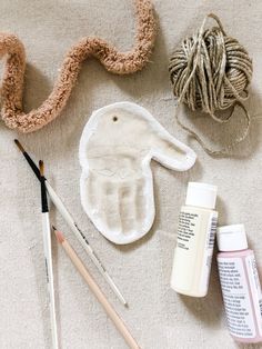 the supplies needed to make an easter bunny craft are laid out next to yarn, paint and crochet hooks