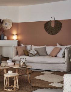 a living room filled with furniture and a fire place next to a wall mounted clock