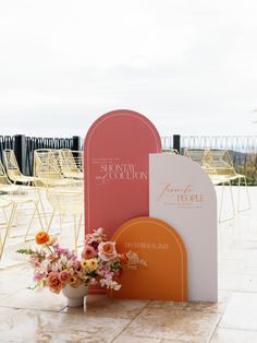 an outdoor ceremony set up with chairs and flowers in vases on the ground next to each other