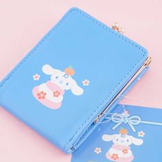 Use this kawaii clutch purse to keep your loose change. "Gamaguchi" is a traditional pouch in Japan and is considered a lucky purse! It features a ribbon and is printed with illustrations of Cinnamoroll and Milk. It has a golden metal clasp so you can easily secure your coins. A super cute Japanese pouch featuring the Cinnamoroll and Milk Features an inner pocket, a ribbon, and a golden metal clasp Original licensed product from Sanrio Japan Cute Blue Rectangular Wallet, Kawaii Coin Purse With Card Slots For Gift, Kawaii Wallet With Card Slots, Kawaii Rectangular Wallets With Card Slots, Cute Blue Wallets For Gifts, Cute Blue Wallets For Gift, Cute Blue Rectangular Coin Purse, Cute Rectangular Wallets For Gifts, Cute Rectangular Coin Purse For School