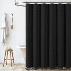 a black shower curtain in a white bathroom