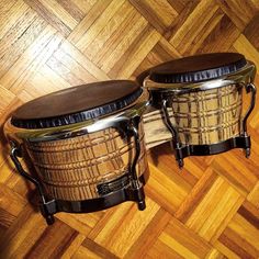 two drums sitting on top of a wooden floor