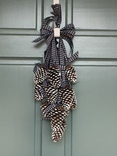 a black and white wreath hanging on a green door