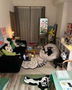 a living room filled with furniture and lots of stuffed animals on top of the floor