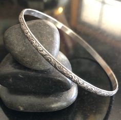 This listing is for one Sterling Silver Stacking Southwestern style floral Bangle Bracelet. This bangle is 3.55mm x 1.52mm thick and is sure to be a unique addition to your favorite stacking bangle bracelets! Lovely pattern All bangles are soldered, hammered, tumbled for hours and hand-polished just for you! My bangle sizes are available in the following sizes: Small - 2 1/4 inch diameter - Petite Adult 7 inch circumference Medium - 2 1/2 inch diameter - 8 inch circumference (common) Large - 2 3 Silver Bangles Design Silver Bangles Design For Women, Silver Bangle Bracelets Unique Modern, Southwestern Bangle Bracelet For Gift, Bohemian Etched Sterling Silver Bangle, Silver Bangle Bracelets Unique, Bangle Stacking, Silver Jewellry, Stacking Bangles, Bridal Jewelry Sets Brides