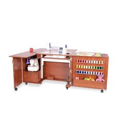 a wooden desk with sewing supplies on it