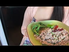 a woman holding a plate with food in it