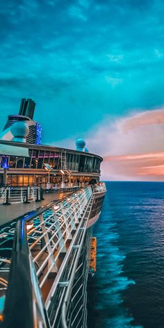 the top deck of a cruise ship at dusk with blue sky and clouds in the background