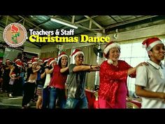 a group of people wearing christmas hats and dancing in front of an audience with the words teachers & staff christmas dance