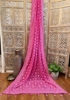 A very very pretty Chikankari saree in pure georgette in a lovely candy pink shade with all over jaal (barfi pattern) embroidery with mukaish work (embellishments). The pallu is short but features intricate designs. The entire saree has the same pattern from the very beginning of the saree except the portion you have to tuck in so that it doesn’t bulge. Entire saree is framed in cord piping, best quality satin falls are attached and picot stitching is done as well. The blouse piece is separated Pink Bandhani Print Pre-draped Saree For Festivals, Pink Bandhani Print Pre-draped Saree For Diwali, Festive Pink Bandhani Print Pre-draped Saree, Pink Semi-stitched Pre-draped Saree With Bandhani Print, Pink Bandhani Print Pre-draped Saree, Pink Pre-draped Saree With Chikankari Embroidery For Eid, Pink Dupatta With Resham Embroidery In Georgette, Pink Georgette Traditional Wear With Cutdana, Pink Anarkali Saree With Bandhani Print