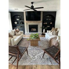 a living room filled with furniture and a fire place