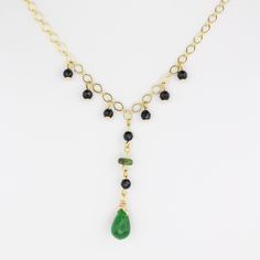 This handcrafted gemstone necklace features a stunning arrangement of one green Jade gemstone, eight Black Onyx gemstones, and one Serpentinite gemstone, all beautifully dangling from a 24K gold-filled chain. Measuring 20" long, the chain can easily be shortened to your desired length, while the Jade teardrop pendant adds an elegant 2" drop. Jade is believed to boost luck, bring relaxation, and harmonize relationships; Serpentinite is believed to build confidence, boost positivity, and balance e Elegant Onyx Wire Wrapped Necklace, Handmade Gold Onyx Necklaces, Gold Onyx Necklaces With Natural Stones, Gold Onyx Necklace With Adjustable Chain, Gold Onyx Gemstone Necklace, Elegant 14k Gold-filled Necklaces With Natural Stones, Serpentine Stone, Pearl Charm Necklace, Jade Gemstone