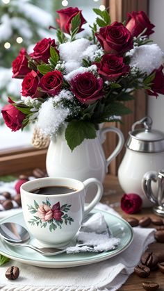 a cup of coffee on a saucer with red roses