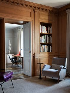 a living room filled with furniture and bookshelves