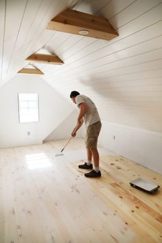 a man with a mop in an empty room