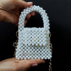 The unique mini bag is perfect for your Airpods or can be used as a card holder. The bag is made of 8 mm crystal beads intertwined with light 0.5 mm beads. The bag closes with a magnetic button. Dimensions:10,5cm×9cm (without handle), 16cm (with handle)× 3,5 cm Trendy White Handheld Evening Bag, Trendy Evening Bag With Pearl Handle For Gift, Trendy Evening Bag With Pearl Handle As Gift, Trendy White Square Evening Bag, White Handheld Bag With Pearl Handle, Trendy White Pouch Evening Bag, White Evening Bag With Pearl Handle As A Gift, White Shoulder Bag With Pearl Handle As Gift, Trendy White Shoulder Bag With Pearl Handle