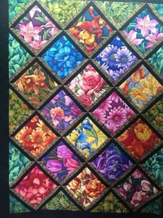 a colorful quilt with flowers on it