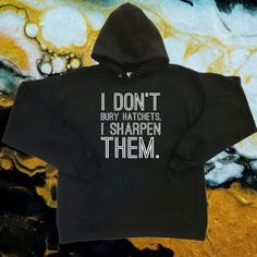 Long Sleeve Black Graphic Hoodie. New Without Tags. "I Don't Bury Hatchets, I Sharpen Them" White Vinyl Lettering On Chest/Torso Of The Hoodie. Hoodies Made To Order. Designs Made Using Htv. Hanes Brand 50/50 Polyester/Cotton Sizes Available: S - 2xl Small Body Width: 20 Inches Body Length: 26.5 Inches Sleeve Length: 24.38 Inches Medium Body Width: 22 Inches Body Length: 27.5 Inches Sleeve Length: 24.63 Inches Large Body Width: 24 Inches Body Length: 28.5 Inches Sleeve Length: 24.24 Inches X-Lar Pre-shrunk Black Hoodie For Winter, Black Pre-shrunk Hoodie For Winter, Winter Black Pre-shrunk Hoodie, Black Graphic Hoodie, Vinyl Lettering, White Vinyl, Colorful Hoodies, Graphic Hoodie, 50 50