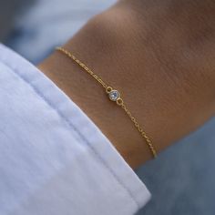 "Super cute bezel bracelet is great for layering or worn on its own! Delicate & dainty this is perfect for a minimalist look :) - - - D E T A I L S - - -  * Made of 925 Sterling Silver * THICK plating of 14k Gold or Rhodium  * Available in 6.25\", 6.75\" + .5\" Ext Chain lengths * 4mm Bezel * Nickel-free & Hypoallergenic  * Lobster clasp closure with extension chain  Bracelets on Model: TENNIS BRACELET --> https://www.etsy.com/listing/899893520/tennis-bracelet-gold-tennis-bracelet? click_key=7b87b1a3c5a7ba74e2318e00058ba68f4b95e9ad%3A899893520&click_sum=5ad98715&ga_search_query=tennis%2Bbracelet&ref=shop_items_search_3&pro=1&sts=1 Beaded Bracelet --> https://www.etsy.com/listing/1330606182/beaded-bracelet-dainty-bracelet?click_key=1ddd85cabdfc074c2afb8a761e05b152f0e045ab%3A1330606182&click Diamond Bezel Bracelet, Gold Bracelet Simple, Bezel Bracelet, Bracelet Tennis, Cz Bracelet, Gold Armband, Chain Bracelets, Demi Fine Jewelry, Minimalist Bracelet