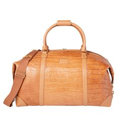 Built with Lucchese's own giant American alligator, this signature duffle totes your essentials in first class style. The fold-end construction allows for maximum packing space, which includes natural, water-resistant canvas lining, an interior zipper pocket and two open storage slots. American Alligator, Handcrafted Boots, Handmade Boot, Open Storage, You Bag, Alligator, Zipper Pocket, Slots, Shoulder Strap